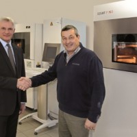 (f.l.t.r.) Stuart Jackson, Regional Manager EOS UK with Richard Brady, Advanced Digital Manufacturing Leader, in front of an EOSINT P 760 system (Source: EOS) 